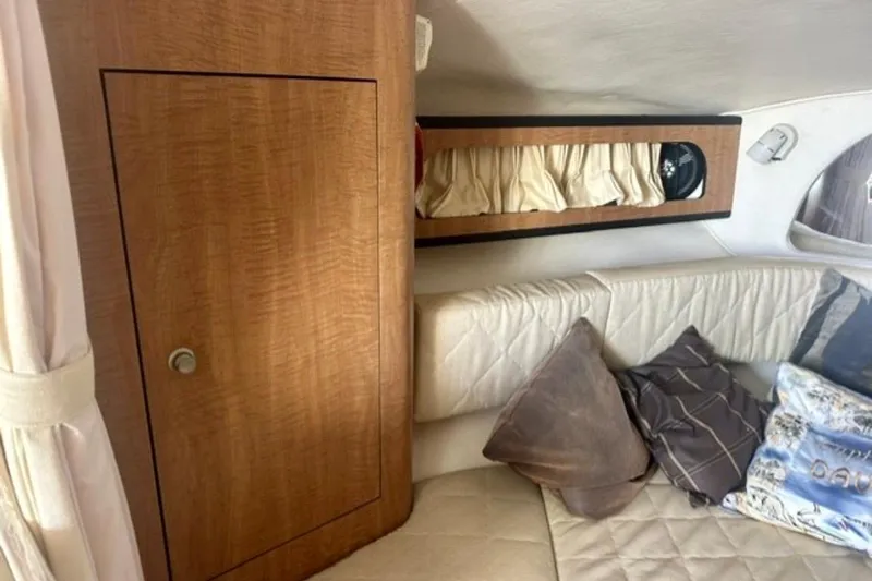 Slide: The Image of Interior of 2006 Sea Ray Sundancer 280 with wood cabinet and cushioned seating area. - 13