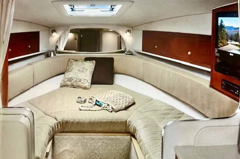 Slide: The Image of Interior of 2006 Sea Ray Sundancer 280, featuring cozy seating and elegant wood accents. - 23