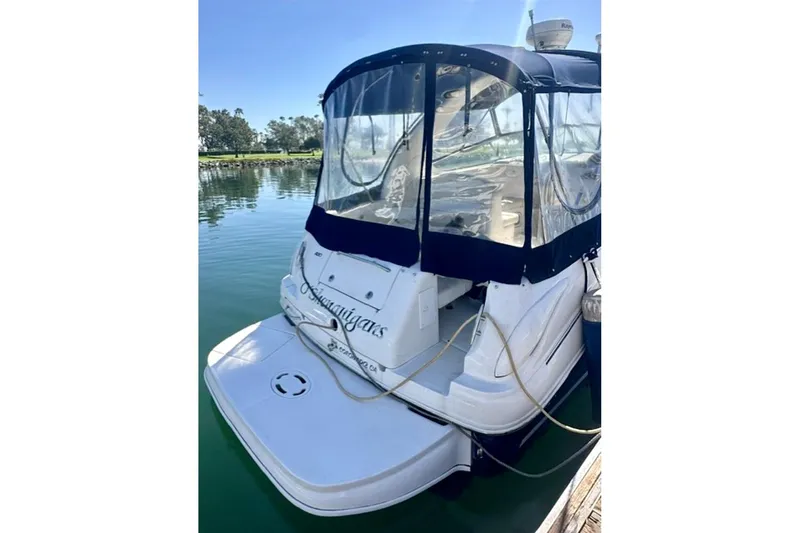 Slide: The Image of 2006 Sea Ray Sundancer 280 docked, featuring a covered cockpit and sleek design. - 4