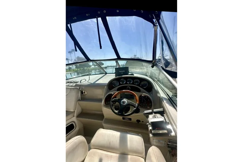 Slide: The Image of Interior view of 2006 Sea Ray Sundancer 280 boat cockpit with steering wheel and controls. - 9