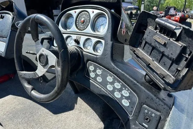 Slide: The Image of 2007 Skeeter ZX250 boat dashboard with steering wheel and control panel. - 11