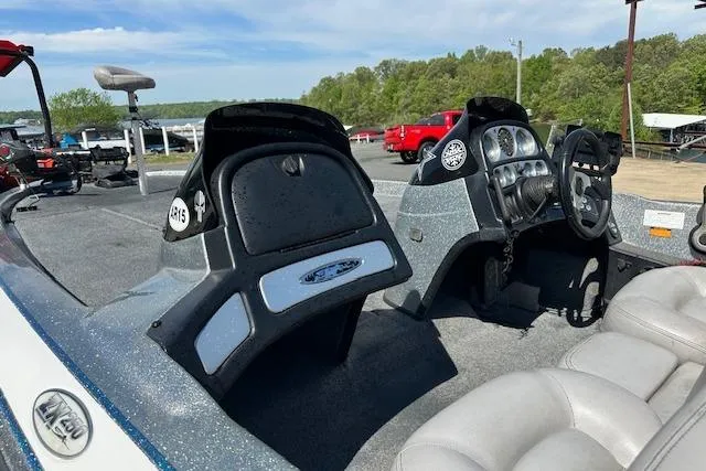Slide: The Image of 2007 Skeeter ZX250 boat interior with dual consoles and steering wheel, parked near a lake. - 13