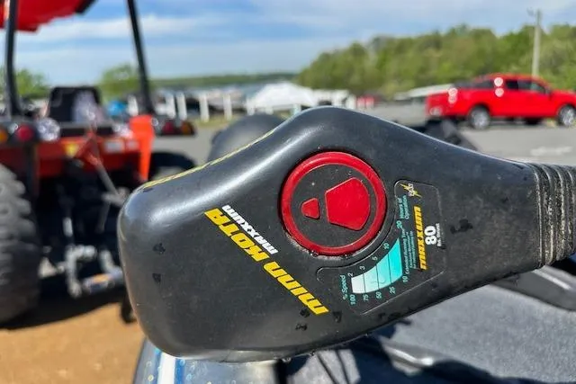 Slide: The Image of Trolling motor control on 2007 Skeeter ZX250 boat, with vehicles in the background. - 16