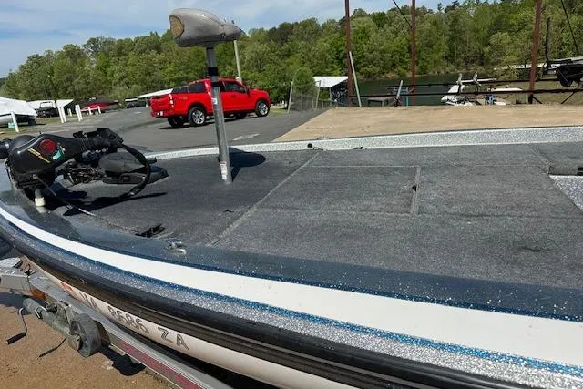 Slide: The Image of 2007 Skeeter ZX250 boat on trailer, with red truck and trees in background. - 17