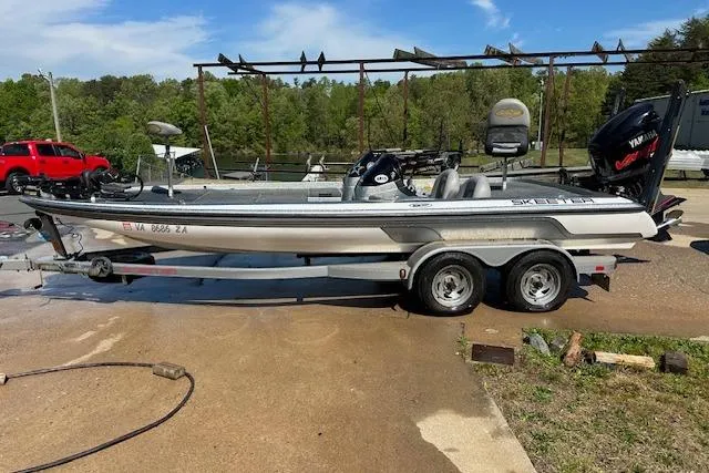 Slide: The Image of 2007 Skeeter ZX250 boat on trailer, parked outdoors near a lake. - 3