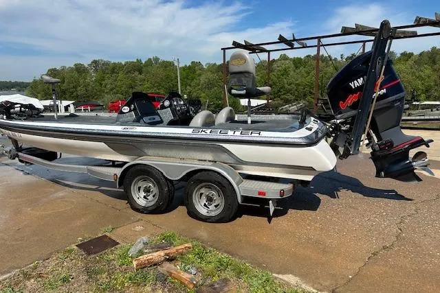 Slide: The Image of 2007 Skeeter ZX250 boat with Yamaha engine on a trailer, parked outdoors. - 5