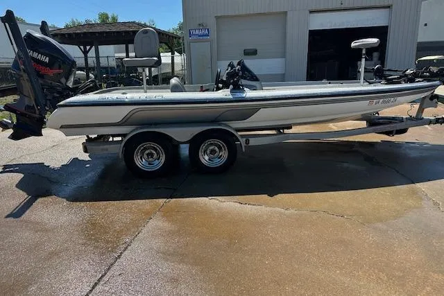 Slide: The Image of 2007 Skeeter ZX250 boat on trailer, parked outside a garage. - 8