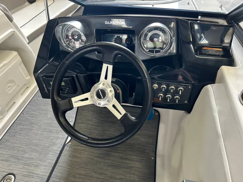 Slide: The Image of Dashboard of a 2022 Glastron 205 GTD boat with steering wheel. - 12