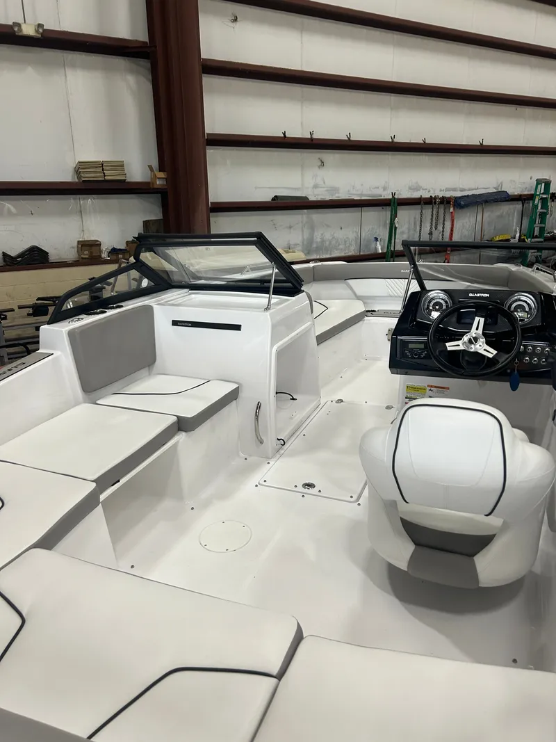 Slide: The Image of Interior of a 2022 Glastron 205 GTD boat in a warehouse. - 9