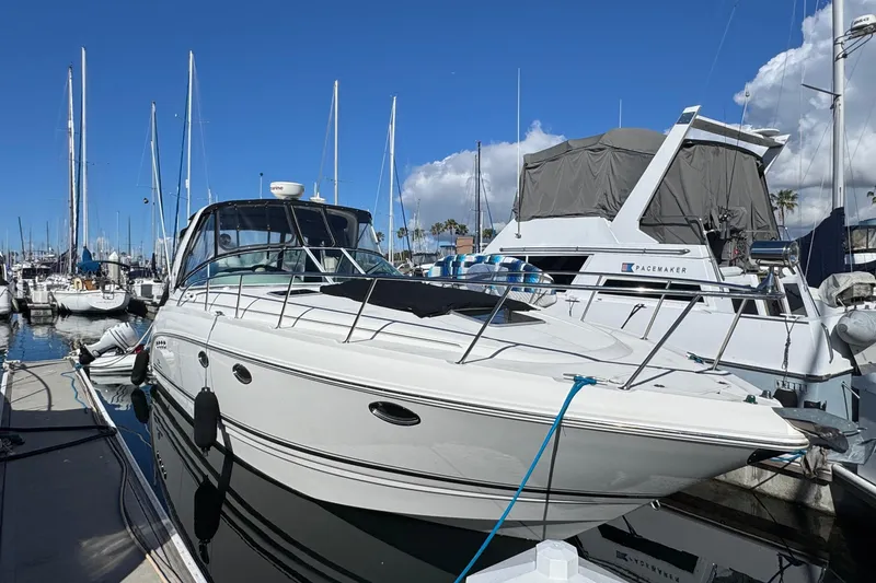 The Image of 2006 Chaparral Signature 350 yacht docked at marina under clear blue sky. - 0