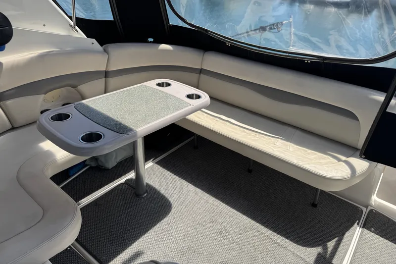Slide: The Image of Interior seating area of 2006 Chaparral Signature 350 boat with table and cup holders. - 13