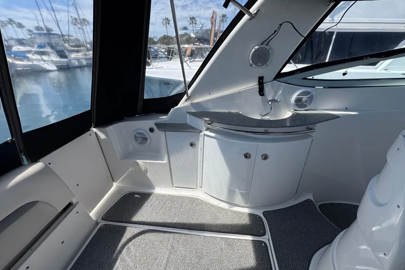 Slide: The Image of 2006 Chaparral Signature 350 boat interior with sink and seating, docked at marina. - 14