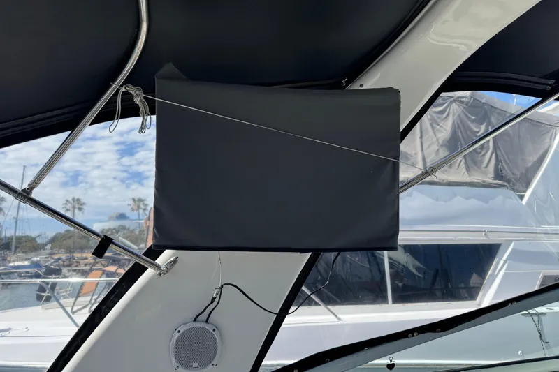 Slide: The Image of 2006 Chaparral Signature 350 boat interior with covered equipment and marina view. - 16