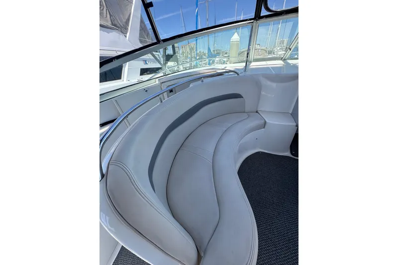 Slide: The Image of 2006 Chaparral Signature 350 boat interior with curved seating and marina view. - 19