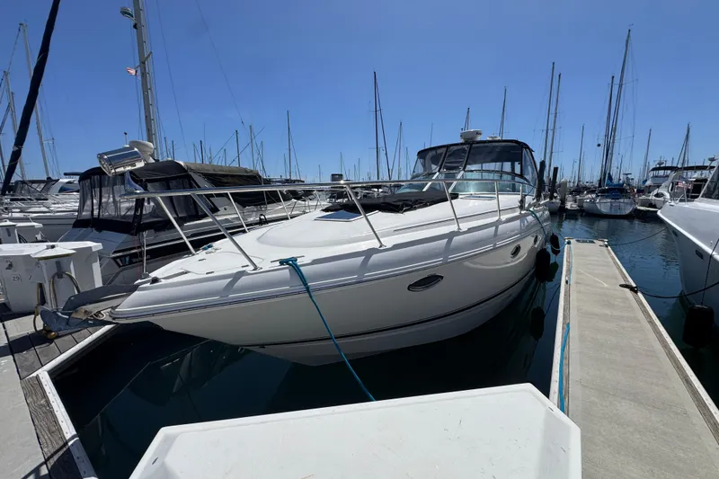 Slide: The Image of 2006 Chaparral Signature 350 yacht docked at marina under clear blue sky. - 2