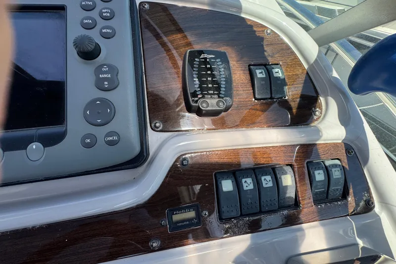 Slide: The Image of Control panel of a 2006 Chaparral Signature 350 boat with switches and navigation controls. - 26