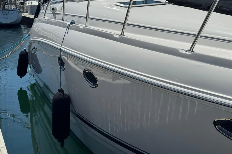Slide: The Image of 2006 Chaparral Signature 350 yacht docked with fenders, reflecting on calm water. - 3