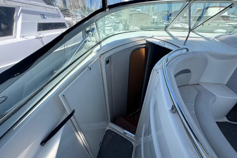Slide: The Image of 2006 Chaparral Signature 350 boat interior with open cabin door and seating area. - 31