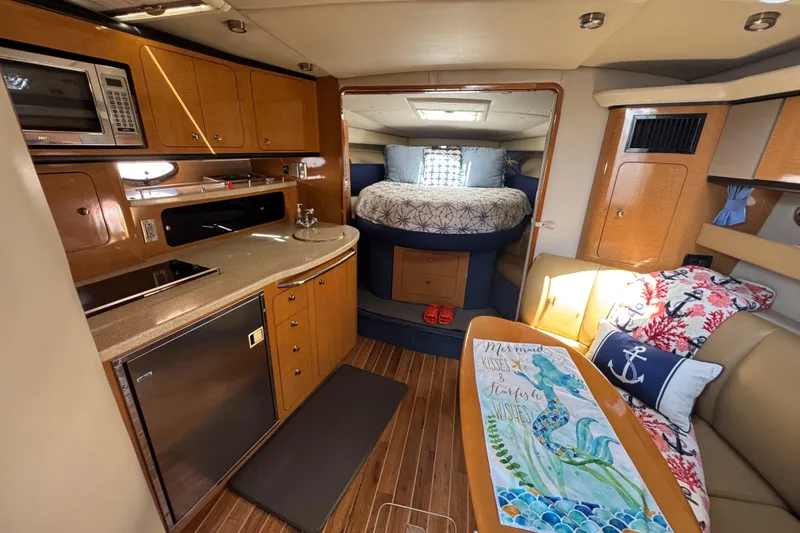 Slide: The Image of Interior of a 2006 Chaparral Signature 350 yacht with kitchen and cozy seating area. - 33
