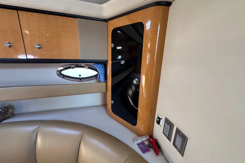 Slide: The Image of Interior of 2006 Chaparral Signature 350 yacht with wood cabinetry and porthole window. - 35