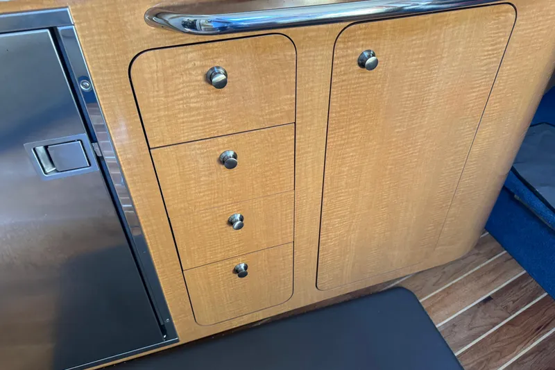 Slide: The Image of 2006 Chaparral Signature 350 interior with wooden cabinets and stainless steel accents. - 39