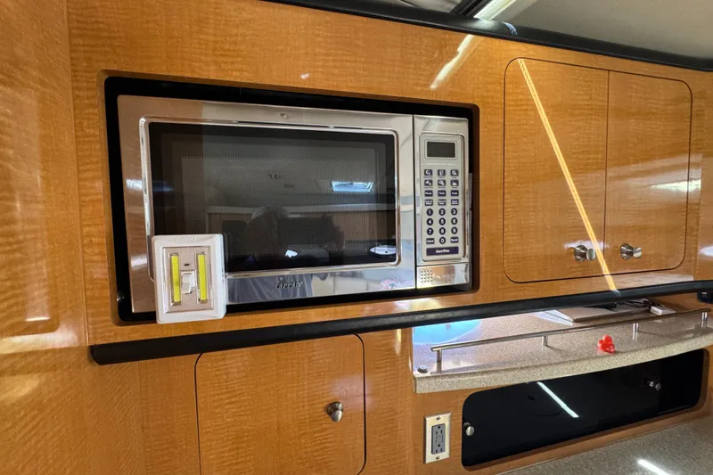 Slide: The Image of 2006 Chaparral Signature 350 interior with microwave and wooden cabinetry. - 40