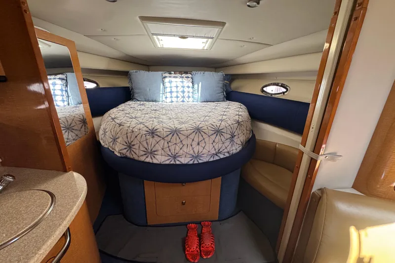 Slide: The Image of Interior cabin of a 2006 Chaparral Signature 350 boat with a cozy bed. - 43