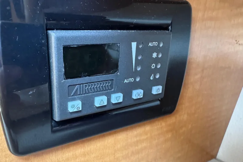 Slide: The Image of Control panel of a 2006 Chaparral Signature 350 boat, featuring various function buttons. - 46