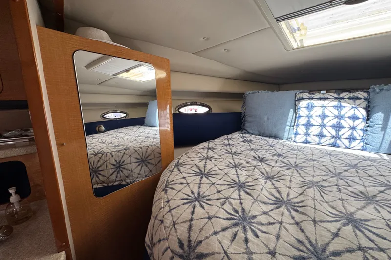 Slide: The Image of Interior cabin of 2006 Chaparral Signature 350 with patterned bedding and mirror. - 47