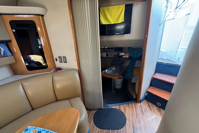 Slide: The Image of Interior of 2006 Chaparral Signature 350 yacht with seating, table, and stairs. - 49