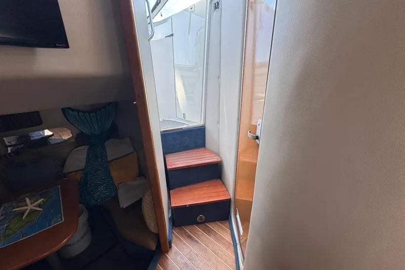 Slide: The Image of Interior view of 2006 Chaparral Signature 350 yacht with wooden steps and cozy seating area. - 52
