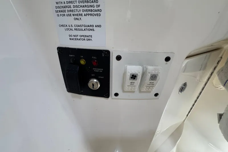 Slide: The Image of Control panel on a 2006 Chaparral Signature 350 boat with discharge and lighting switches. - 54