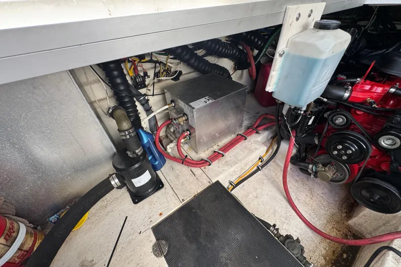 Slide: The Image of Engine compartment of a 2006 Chaparral Signature 350 boat, showing mechanical components and wiring. - 61