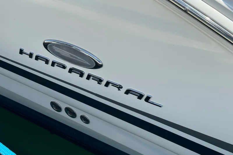 Slide: The Image of 2006 Chaparral Signature 350 boat logo on white hull with chrome accents. - 7