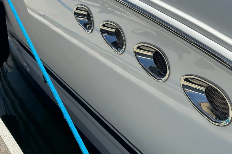 Slide: The Image of Close-up of 2006 Chaparral Signature 350 boat with chrome vents and blue rope. - 8