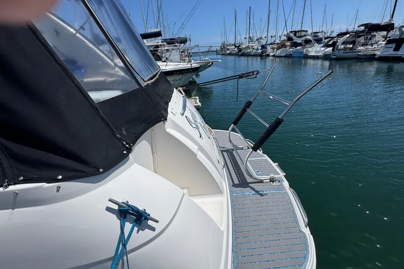 Slide: The Image of 2006 Chaparral Signature 350 yacht docked in a marina with other boats. - 9