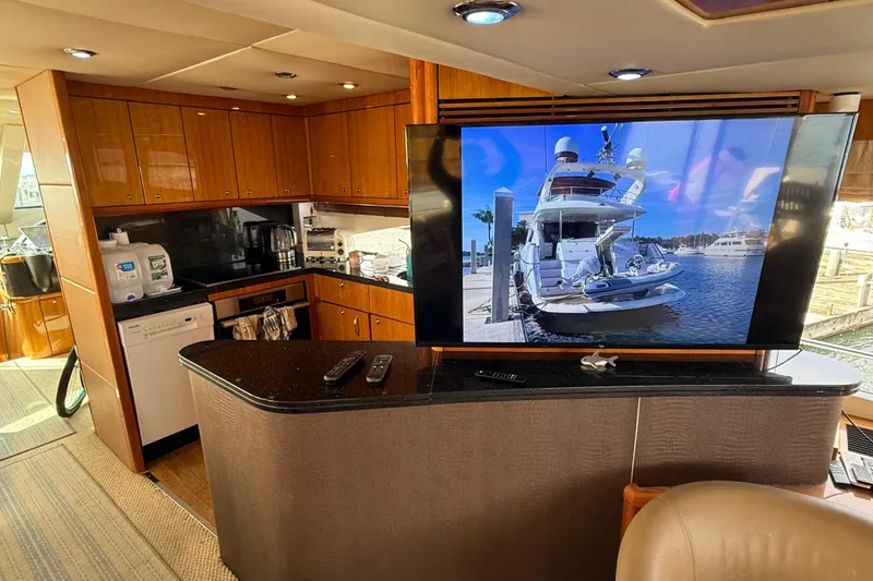 Slide: The Image of Luxurious interior of 2005 Sunseeker 75 Yacht with modern kitchen and large TV display. - 7