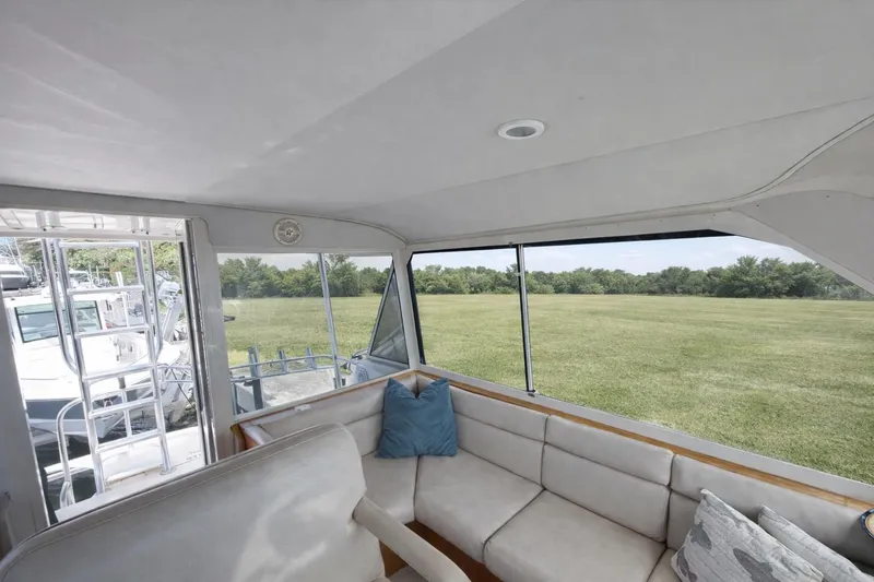Slide: The Image of Interior view of 1990 Hatteras 58 Convertible yacht with comfortable seating and scenic window view. - 11