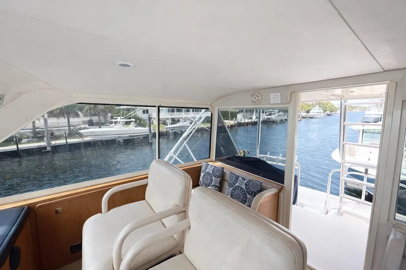 Slide: The Image of Interior view of 1990 Hatteras 58 Convertible yacht with waterfront scenery. - 12