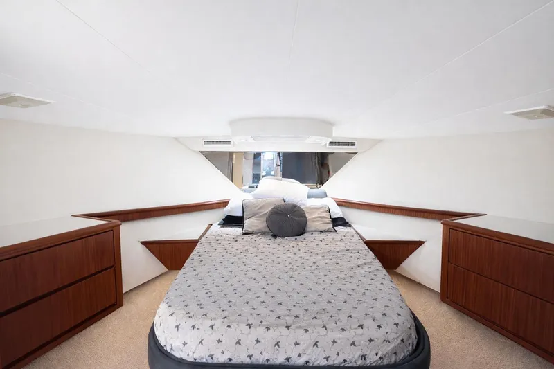 Slide: The Image of Luxurious bedroom interior of 1990 Hatteras 58 Convertible yacht with elegant wood furnishings. - 4