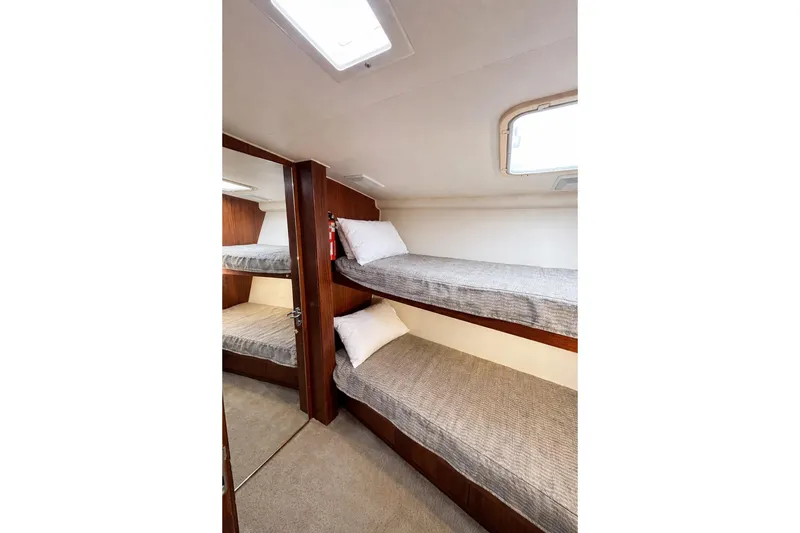 Slide: The Image of Interior of 1990 Hatteras 58 Convertible yacht with cozy bunk beds. - 8