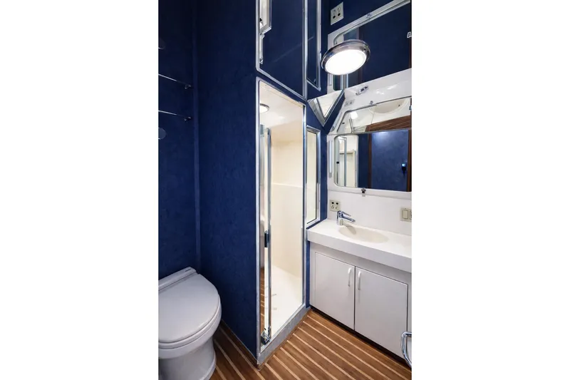 Slide: The Image of Bathroom interior of 1990 Hatteras 58 Convertible yacht with blue walls and wood flooring. - 9