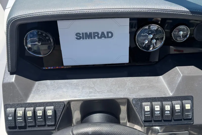 Slide: The Image of Dashboard of 2023 Monterey M-45 boat featuring Simrad display and control switches. - 19