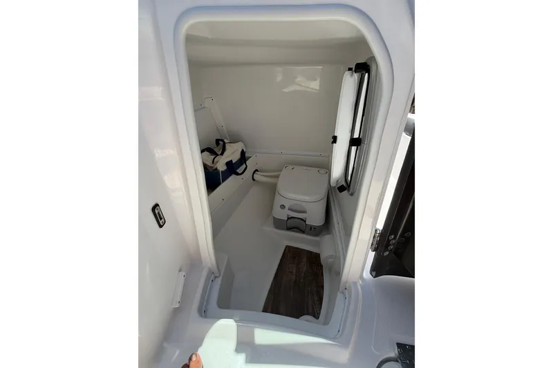 Slide: The Image of 2023 Monterey M-45 boat interior with compact marine toilet and storage area. - 25