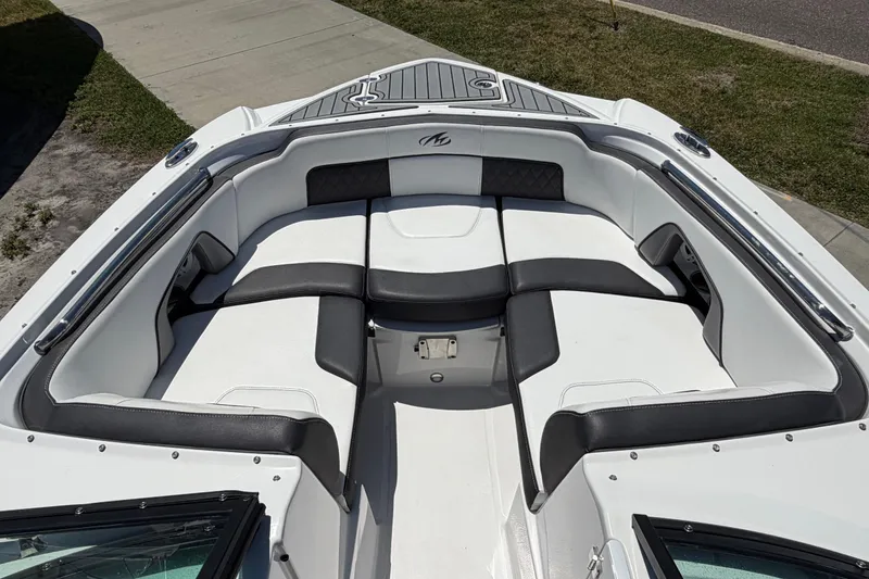 Slide: The Image of 2023 Monterey M-45 boat interior with white and black seating, docked on grass. - 26