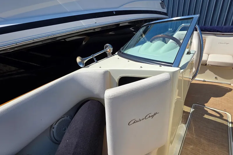 Slide: The Image of 2018 Chris-Craft Launch 23 boat interior with steering wheel and seating. - 11