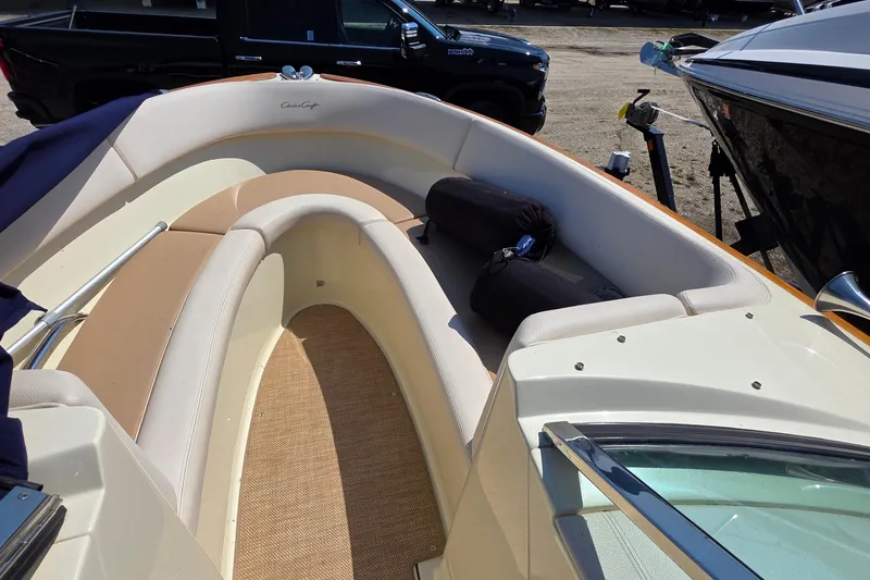 Slide: The Image of 2018 Chris-Craft Launch 23 boat interior with beige seating and carpeted floor. - 13