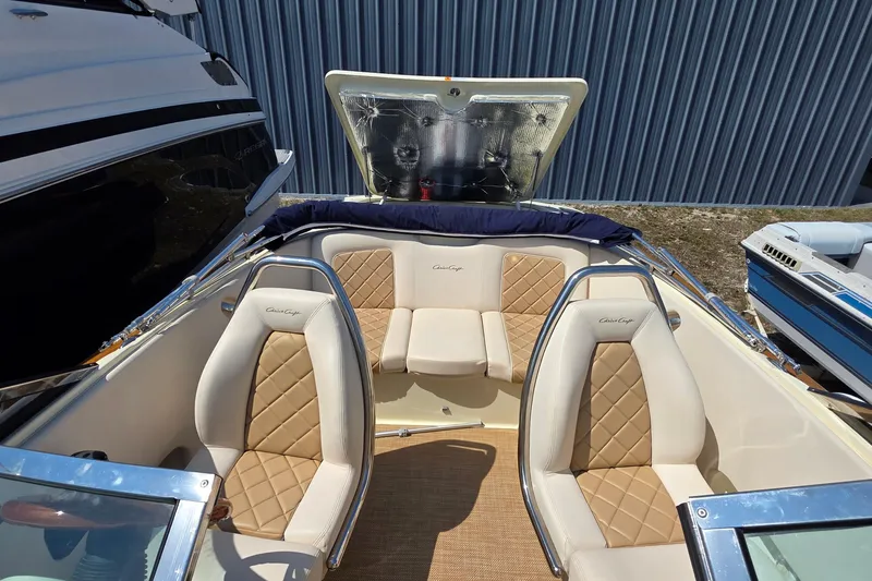 Slide: The Image of 2018 Chris-Craft Launch 23 boat interior with tan diamond-stitched seats and open storage compartment. - 14