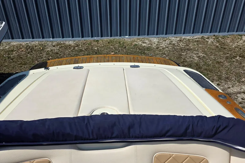Slide: The Image of 2018 Chris-Craft Launch 23 boat with teak accents and cushioned seating. - 18