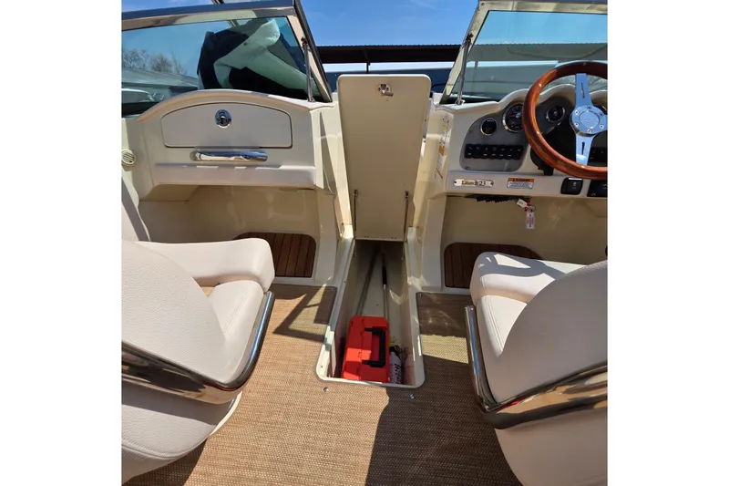 Slide: The Image of 2018 Chris-Craft Launch 23 interior with steering wheel and seating. - 19